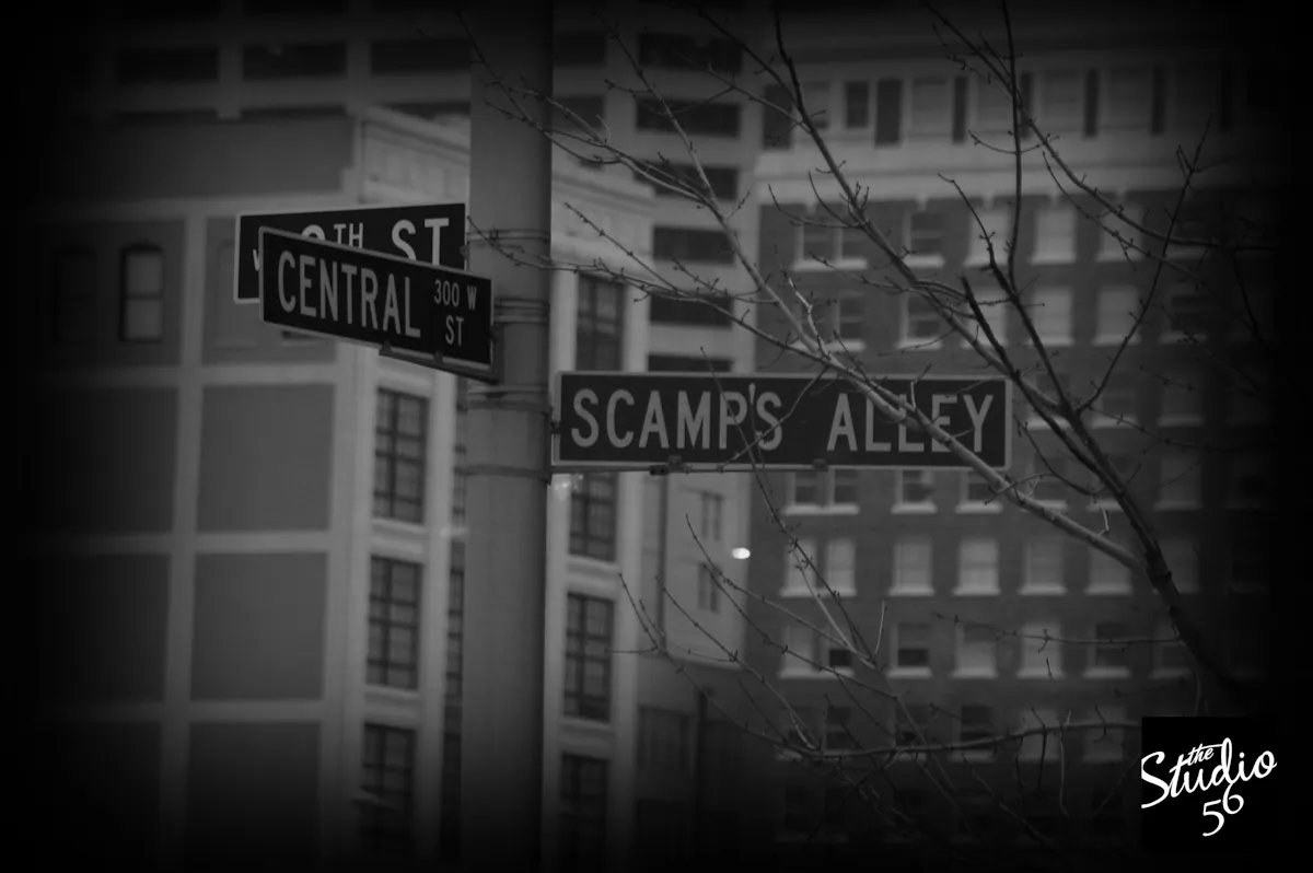 a street sign hanging off the side of a building